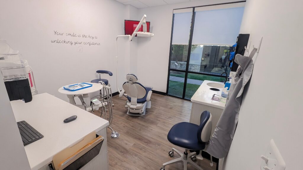 Dolan Dental treatment room with a dental chair and instrument table