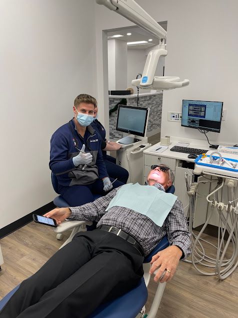 Dentist examining a patient in a treatment chair