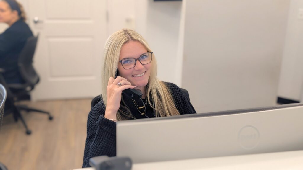 Dolan Dental team member speaking with a patient by phone