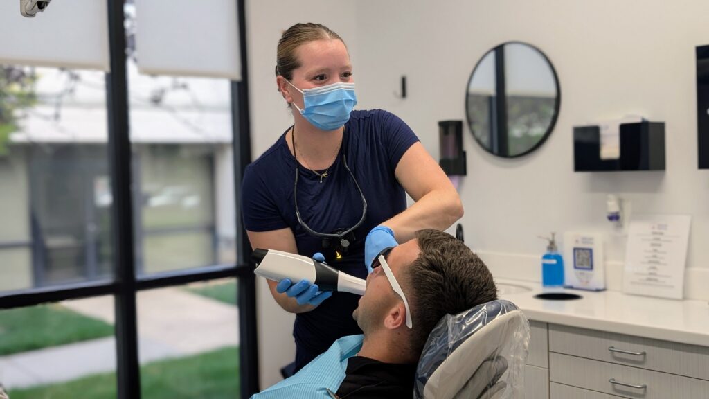 Dental clinician photographing a patient’s smile